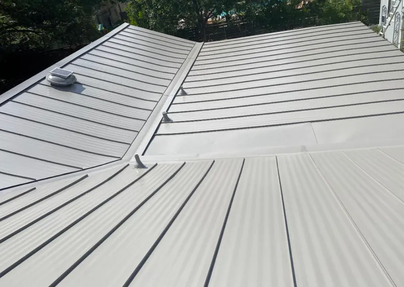 Solar attic fan installed on a metal roof for Roof Ventilation in Flat Rock